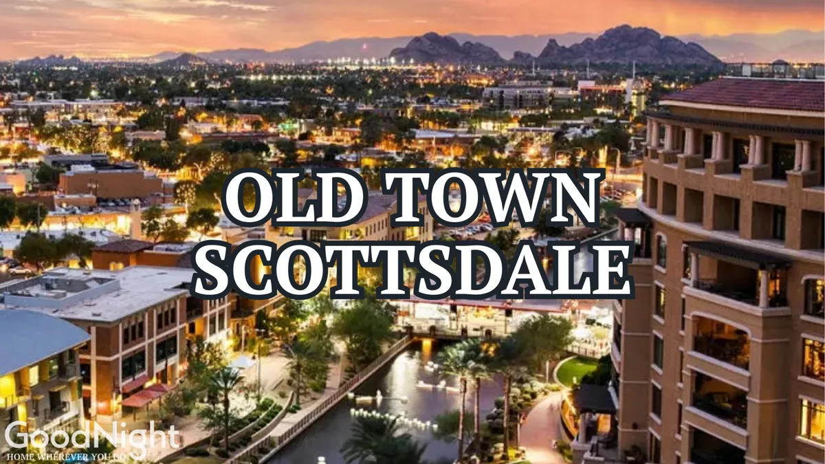 This image features the iconic Old Town Scottsdale sign, a tranquil river or canal, surrounding buildings, and distant mountains. The setting is lively, with people strolling and dining, highlighting the vibrant energy and convenience of the nearby Entertainment District.