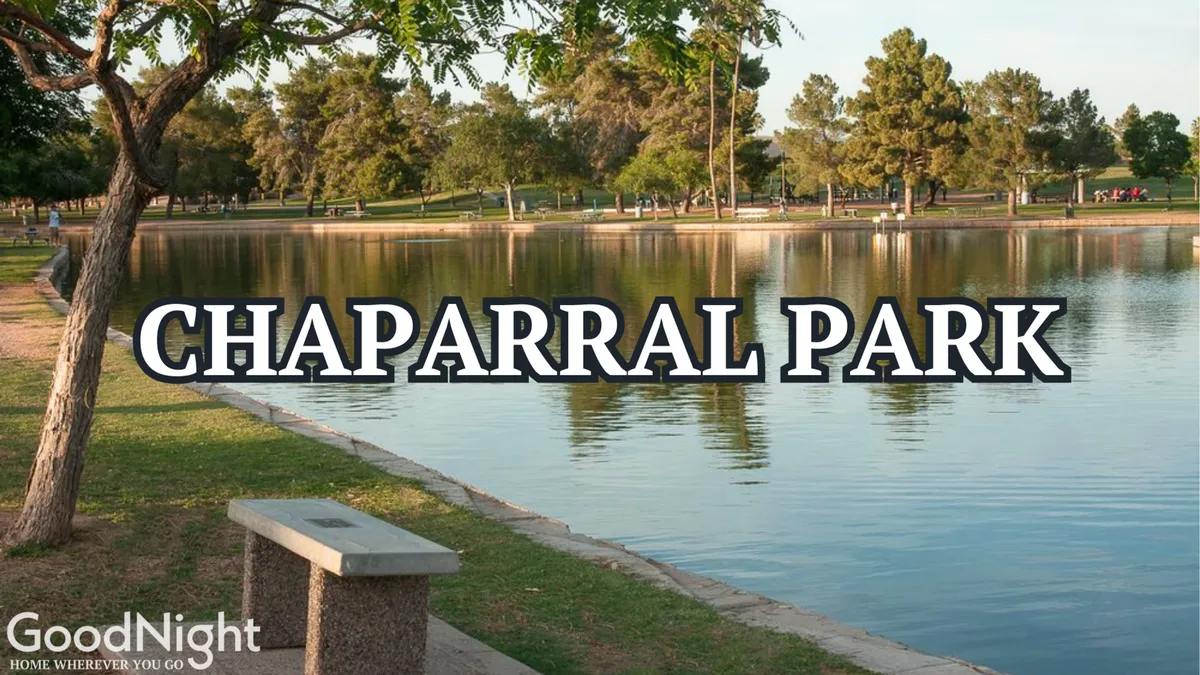 A tranquil park scene with a calm water surface, lush green trees, and park benches along the shoreline. The natural setting embodies relaxation and invites leisurely walks, picnics, or moments of quiet by the water, with the possibility of seeing ducks or other park wildlife.